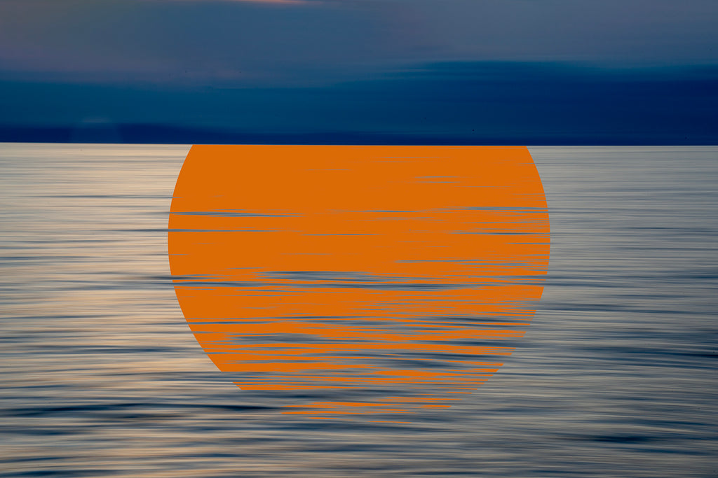 Sunset over water with an orange sun reflection