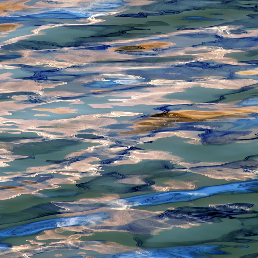 Abstract pattern of blue, green, and beige colors on a textured surface