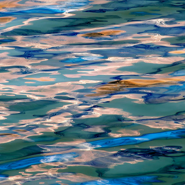 Abstract pattern of blue, green, and beige colors on a textured surface