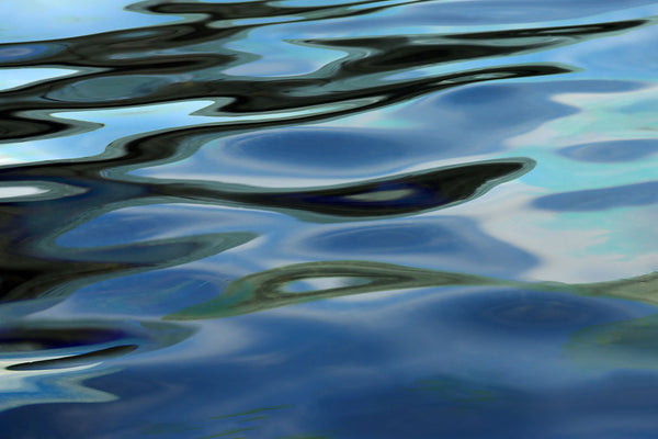 Abstract reflection of blue and green colors on water surface