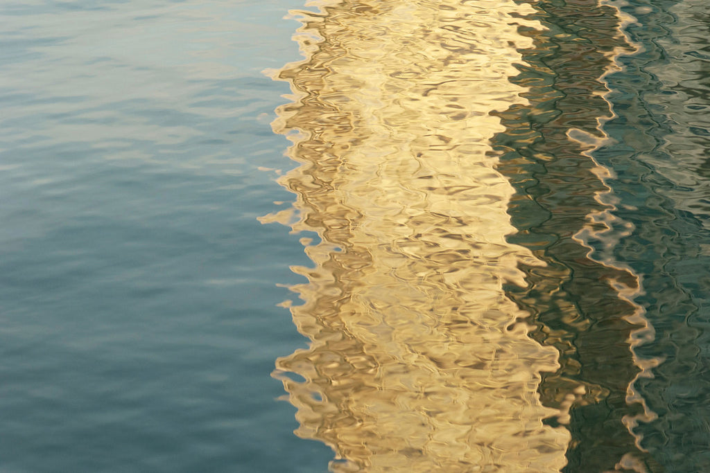 water reflections in gold on the surface of the sea